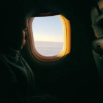 A calm airplane cabin with a relaxed passenger, symbolizing practical steps to overcome your fear of flying and embrace air travel with confidence and peace of mind.