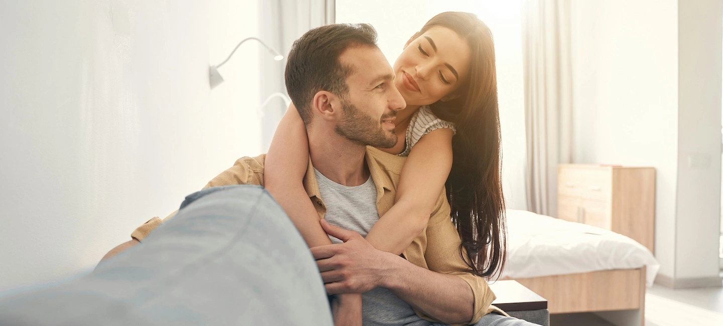Couple sharing a warm, reflective moment at home after travel, symbolizing the integration of meaningful travel insights and experiences into everyday life.